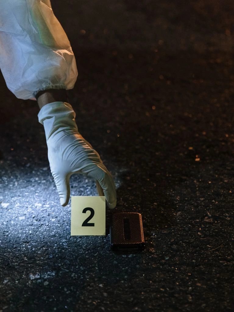 A forensic analyst reviewing an indexed evidence dashboard on a desk monitor.